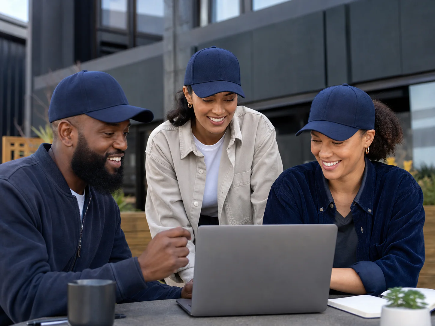Team wearing plain navy caps